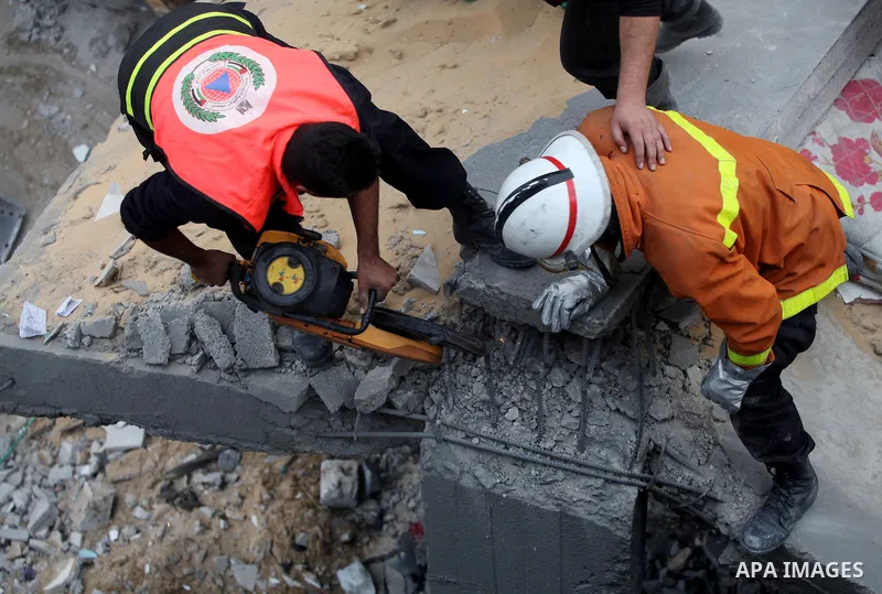 Palestinian firefighters work at the scene of an Israeli air strike on a building in the Jebaliya refugee camp in the northern Gaza Strip, Saturday, Nov. 17, 2012. Israel bombarded the Hamas-ruled Gaza Strip with more th...