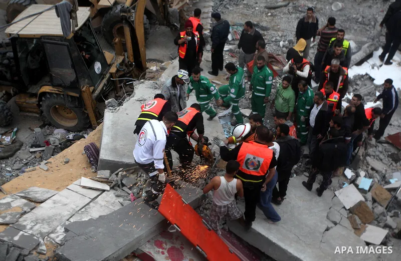 Palestinian firefighters work at the scene of an Israeli air strike on a building in the Jebaliya refugee camp in the northern Gaza Strip, Saturday, Nov. 17, 2012. Israel bombarded the Hamas-ruled Gaza Strip with more th...