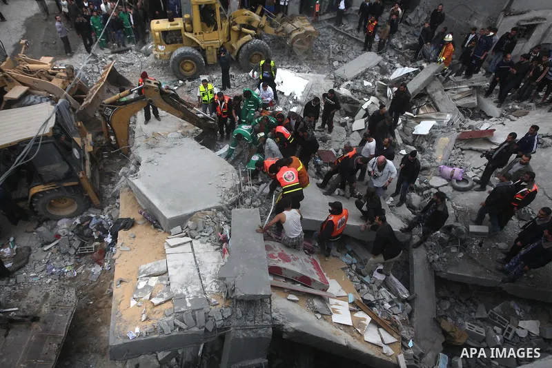 Palestinian firefighters work at the scene of an Israeli air strike on a building in the Jebaliya refugee camp in the northern Gaza Strip, Saturday, Nov. 17, 2012. Israel bombarded the Hamas-ruled Gaza Strip with more th...