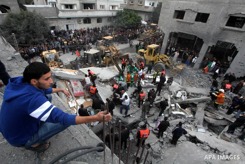 Palestinian firefighters work at the scene of an Israeli air strike on a building in the Jebaliya refugee camp in the northern Gaza Strip, Saturday, Nov. 17, 2012. Israel bombarded the Hamas-ruled Gaza Strip with more th...
