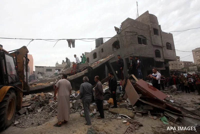 Palestinians inspect the rubble of a destroyed house after an Israeli airstrike in the Jebaliya refugee camp, northern Gaza Strip, Saturday, Nov. 17, 2012. Israel bombarded the Hamas-ruled Gaza Strip with more than 180 a...