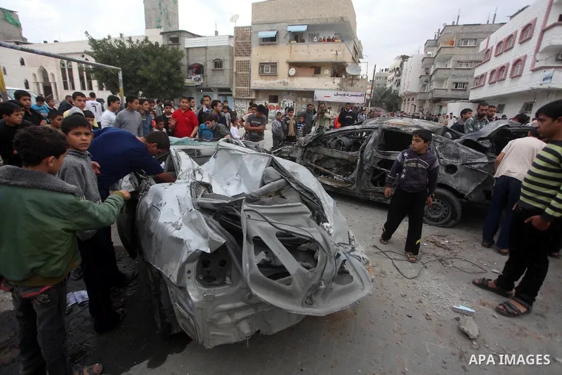 Palestinians inspect the rubble of a destroyed car after an Israeli airstrike in the Jebaliya refugee camp, northern Gaza Strip, Saturday, Nov. 17, 2012. Israel bombarded the Hamas-ruled Gaza Strip with more than 180 air...
