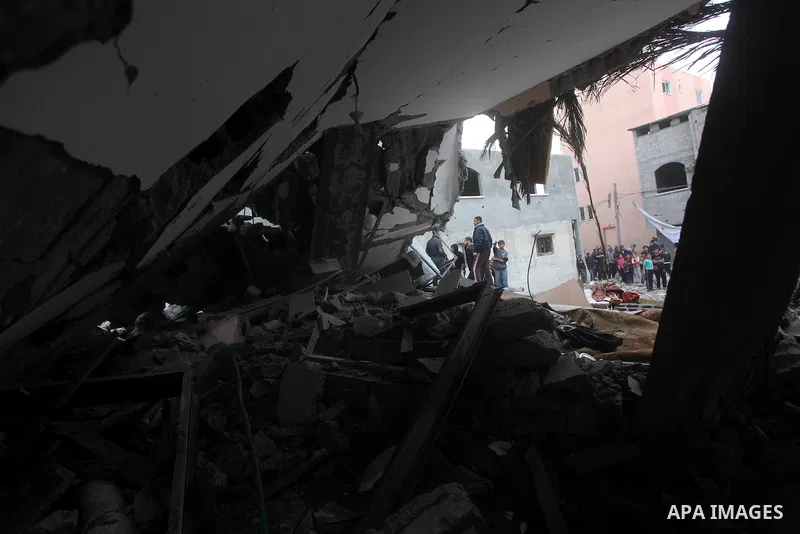 Palestinians inspect the rubble of a destroyed house after an Israeli airstrike in the Jebaliya refugee camp, northern Gaza Strip, Saturday, Nov. 17, 2012. Israel bombarded the Hamas-ruled Gaza Strip with more than 180 a...
