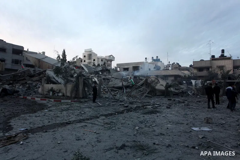 Palestinians inspect the rubble of a destroyed house after an Israeli airstrike in the Jebaliya refugee camp, northern Gaza Strip, Saturday, Nov. 17, 2012. Israel bombarded the Hamas-ruled Gaza Strip with more than 180 a...