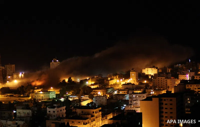 Smoke rises after Israeli air strike at Arafat city police in Gaza City on November 17, 2012. Israeli aircraft pounded Hamas government buildings in Gaza on Saturday, including the building housing the prime minister's o...