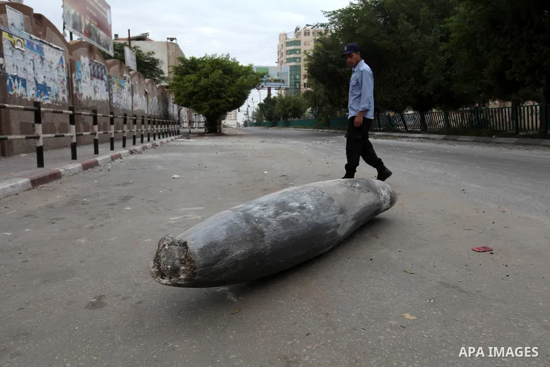 A Hamas policeman stands near an unexploded missile fired by an Israeli aircraft in Gaza City November 17, 2012. Israeli aircraft pounded Hamas government buildings in Gaza on Saturday, including the building housing the...