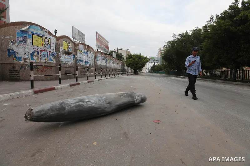 A Hamas policeman stands near an unexploded missile fired by an Israeli aircraft in Gaza City November 17, 2012. Israeli aircraft pounded Hamas government buildings in Gaza on Saturday, including the building housing the...