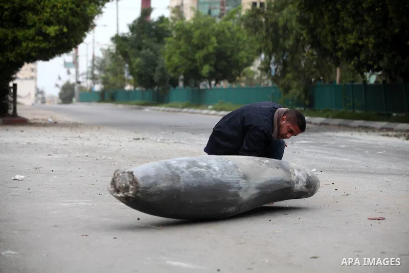 A Hamas policeman looks at an unexploded missile fired by an Israeli aircraft in Gaza City November 17, 2012. Israeli aircraft pounded Hamas government buildings in Gaza on Saturday, including the building housing the pr...