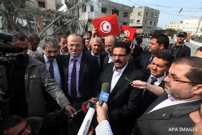 Tunisia's Foreign Minister Rafik Abdessalem visits the office building of Hamas Prime Minister Ismail Haniyeh that was destroyed by an Israeli air strike in Gaza City November 17, 2012. Israeli aircraft pounded Hamas gov...