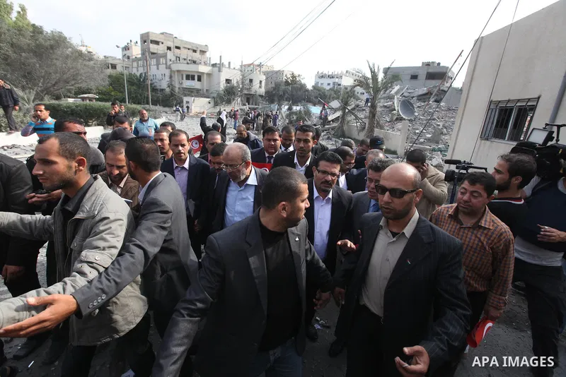 Tunisia's Foreign Minister Rafik Abdessalem visits the office building of Hamas Prime Minister Ismail Haniyeh that was destroyed by an Israeli air strike in Gaza City November 17, 2012. Israeli aircraft pounded Hamas gov...