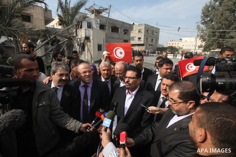 Tunisia's Foreign Minister Rafik Abdessalem visits the office building of Hamas Prime Minister Ismail Haniyeh that was destroyed by an Israeli air strike in Gaza City November 17, 2012. Israeli aircraft pounded Hamas gov...