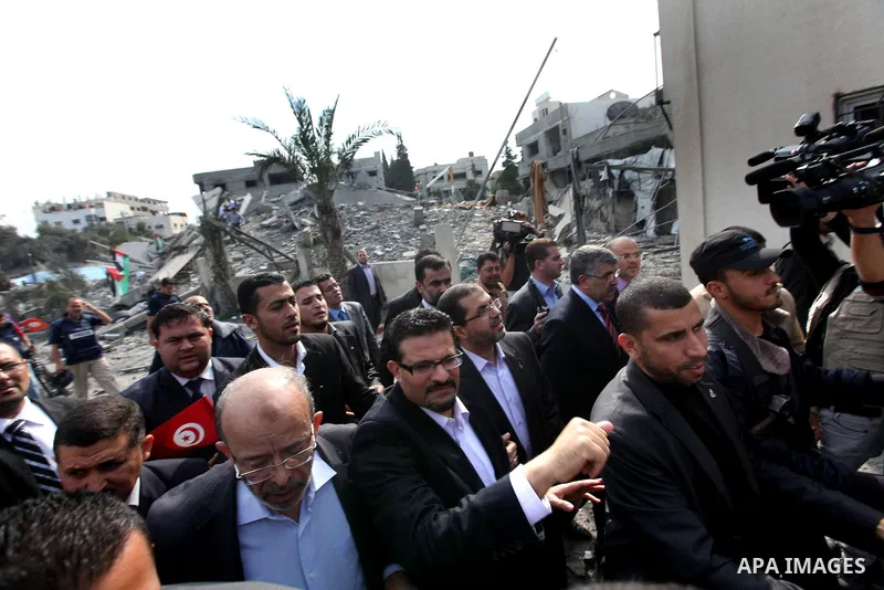 Tunisia's Foreign Minister Rafik Abdessalem visits the office building of Hamas Prime Minister Ismail Haniyeh that was destroyed by an Israeli air strike in Gaza City November 17, 2012. Israeli aircraft pounded Hamas gov...