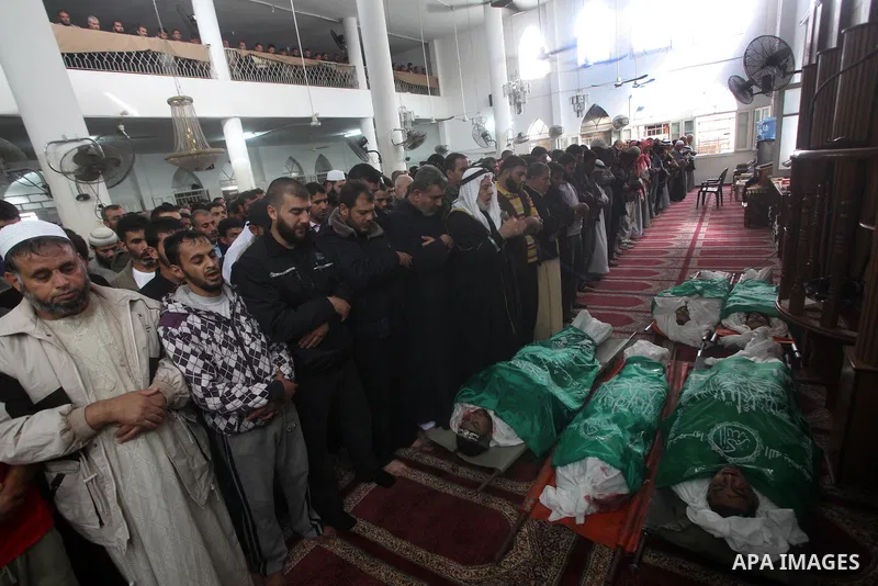 Palestinians surround the bodies of a Hamas militant, who was killed in an Israeli air strike, during his funeral at a mosque in the central Gaza Strip November 17, 2012. Israeli aircraft bombed Hamas government building...