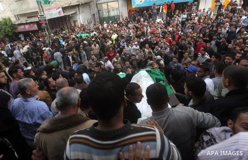Palestinian mourners carry the bodies of a man during the funeral of people killed in Israeli air strikes in Maghazi refugee camp in central Gaza Strip on November 17, 2012. Israeli strikes on Gaza killed at least eight...