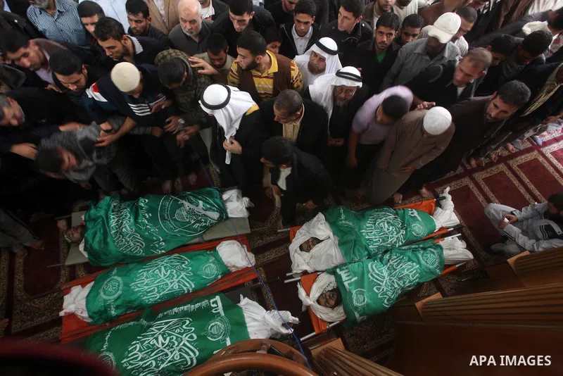 Palestinians surround the bodies of a Hamas militant, who was killed in an Israeli air strike, during his funeral at a mosque in the central Gaza Strip November 17, 2012. Israeli aircraft bombed Hamas government building...