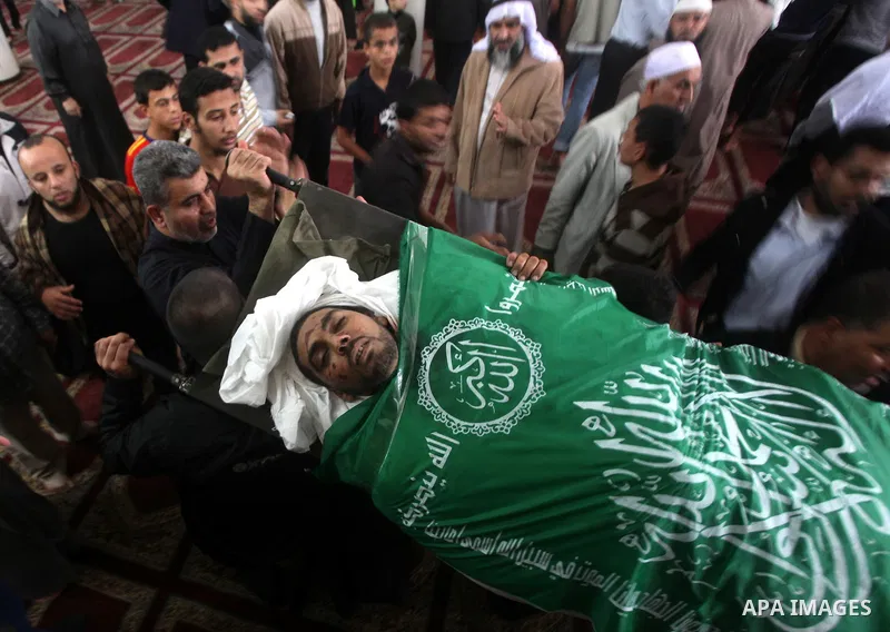 Palestinians surround the bodies of a Hamas militant, who was killed in an Israeli air strike, during his funeral at a mosque in the central Gaza Strip November 17, 2012. Israeli aircraft bombed Hamas government building...