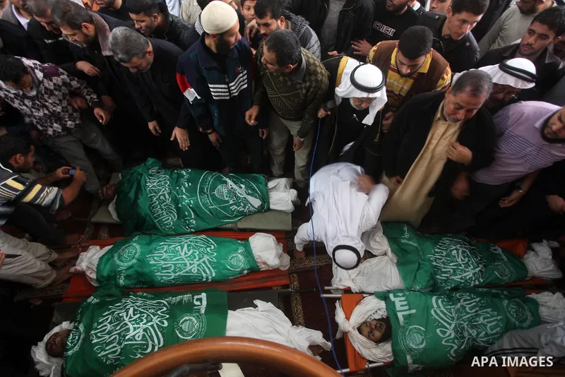 Palestinians surround the bodies of a Hamas militant, who was killed in an Israeli air strike, during his funeral at a mosque in the central Gaza Strip November 17, 2012. Israeli aircraft bombed Hamas government building...