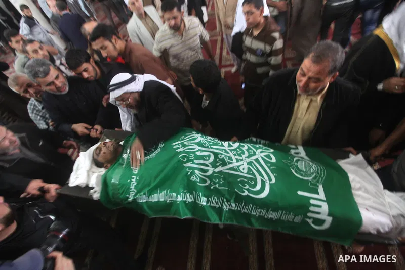 Palestinians surround the bodies of a Hamas militant, who was killed in an Israeli air strike, during his funeral at a mosque in the central Gaza Strip November 17, 2012. Israeli aircraft bombed Hamas government building...