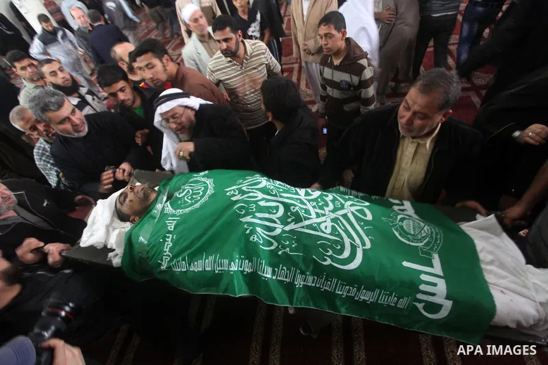 Palestinian mourners carry the bodies of a man during the funeral of people killed in Israeli air strikes in Maghazi refugee camp in central Gaza Strip on November 17, 2012. Israeli strikes on Gaza killed at least eight...