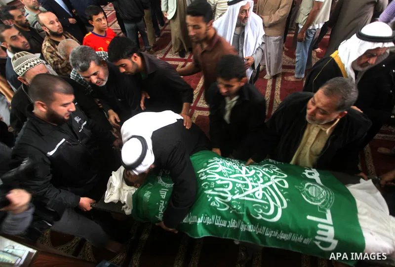 Palestinians surround the bodies of a Hamas militant, who was killed in an Israeli air strike, during his funeral at a mosque in the central Gaza Strip November 17, 2012. Israeli aircraft bombed Hamas government building...