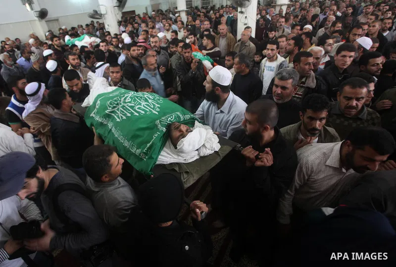 Palestinian mourners carry the bodies of a man during the funeral of people killed in Israeli air strikes in Maghazi refugee camp in central Gaza Strip on November 17, 2012. Israeli strikes on Gaza killed at least eight...
