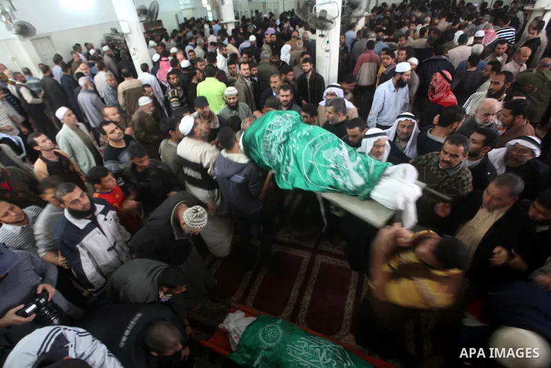 Palestinian mourners carry the bodies of a man during the funeral of people killed in Israeli air strikes in Maghazi refugee camp in central Gaza Strip on November 17, 2012. Israeli strikes on Gaza killed at least eight...