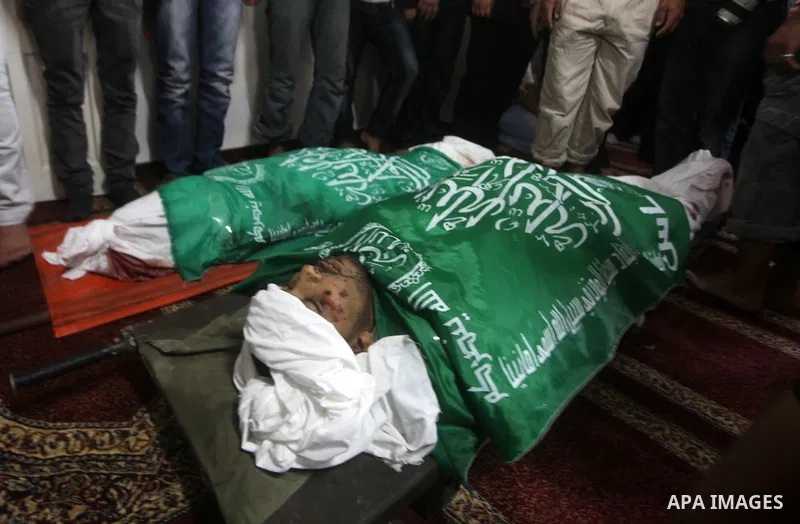 Palestinians surround the bodies of a Hamas militant, who was killed in an Israeli air strike, during his funeral at a mosque in the central Gaza Strip November 17, 2012. Israeli aircraft bombed Hamas government building...