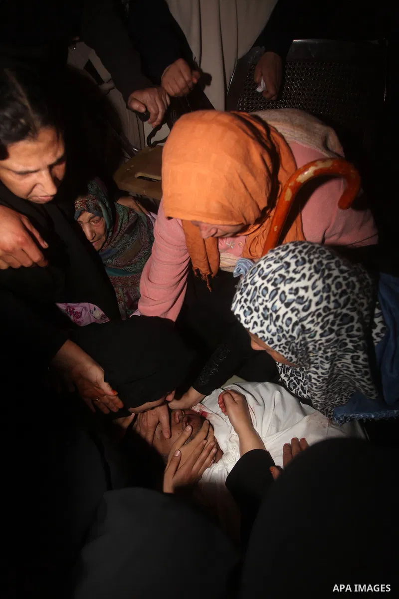Palestinian mourners carry the body of a man during the funeral of people killed in Israeli air strikes in Maghazi refugee camp in central Gaza Strip on November 17, 2012. Israeli strikes on Gaza killed at least eight Pa...