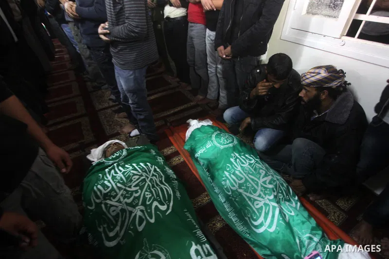 Palestinians surround the bodies of a Hamas militant, who was killed in an Israeli air strike, during his funeral at a mosque in the central Gaza Strip November 17, 2012. Israeli aircraft bombed Hamas government building...