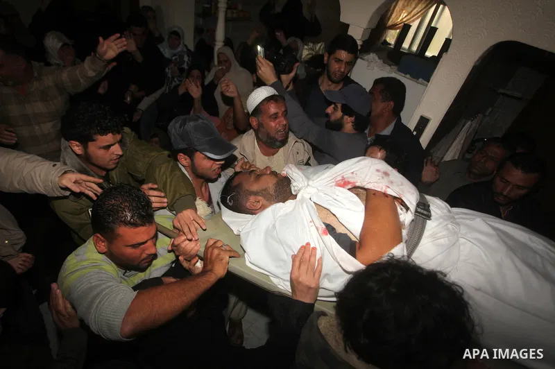 Palestinians surround the bodies of a Hamas militant, who was killed in an Israeli air strike, during his funeral at a mosque in the central Gaza Strip November 17, 2012. Israeli aircraft bombed Hamas government building...
