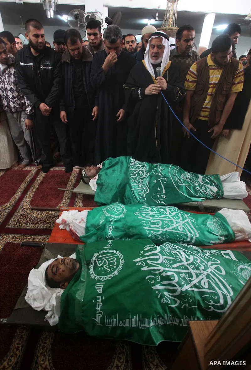 Palestinians surround the bodies of a Hamas militant, who was killed in an Israeli air strike, during his funeral at a mosque in the central Gaza Strip November 17, 2012. Israeli aircraft bombed Hamas government building...