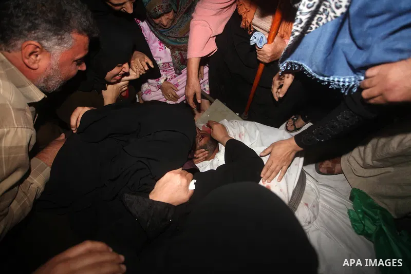 Palestinian mourners carry the body of a man during the funeral of people killed in Israeli air strikes in Maghazi refugee camp in central Gaza Strip on November 17, 2012. Israeli strikes on Gaza killed at least eight Pa...
