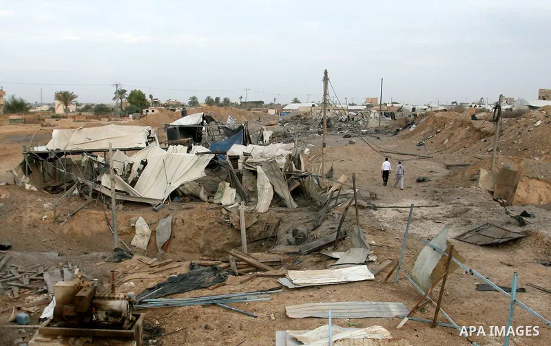 Palestinians inspect the damage at the smuggling tunnels area in the border between Gaza strip and Egypt after Israeli airstrikes in Rafah in the southern Gaza Strip November 16, 2012. Israel bombarded the Hamas-ruled Ga...