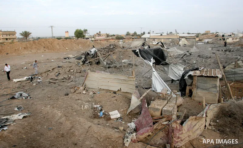 Palestinians inspect the damage at the smuggling tunnels area in the border between Gaza strip and Egypt after Israeli airstrikes in Rafah in the southern Gaza Strip November 16, 2012. Israel bombarded the Hamas-ruled Ga...