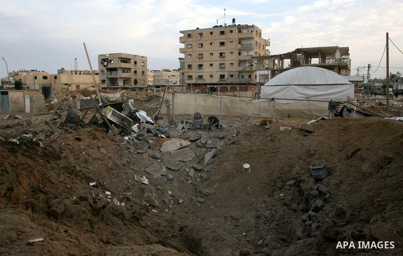 Palestinians inspect the damage at the smuggling tunnels area in the border between Gaza strip and Egypt after Israeli airstrikes in Rafah in the southern Gaza Strip November 16, 2012. Israel bombarded the Hamas-ruled Ga...