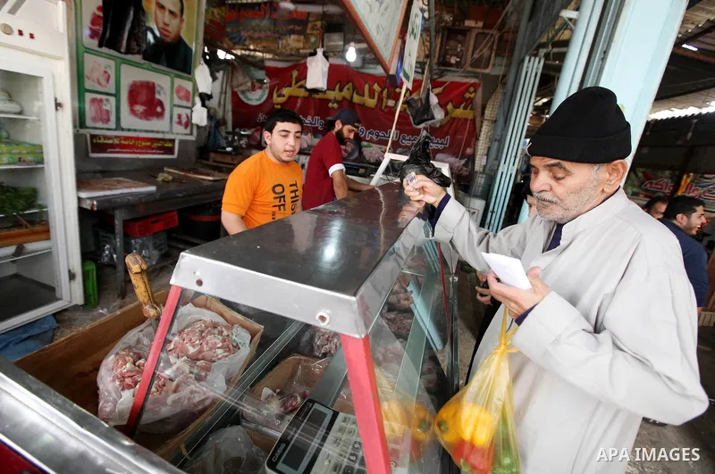 Palestinians shops at a market, while Israeli aircraft continue the military operation on Gaza strip, in central Gaza city on November 17, 2012. Israeli aircraft bombed Hamas government buildings in Gaza on Saturday, inc...