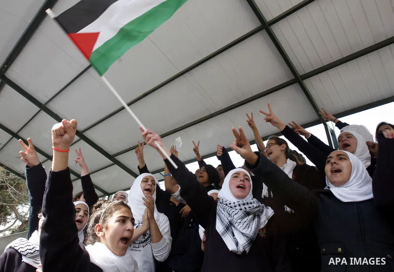 Palestinian students shout slogans during a protest against Israel's military operation in the Gaza Strip, in Jerusalem, on November 17, 2012. Reports state that Israel has put 75,000 reservists on standby amid speculati...