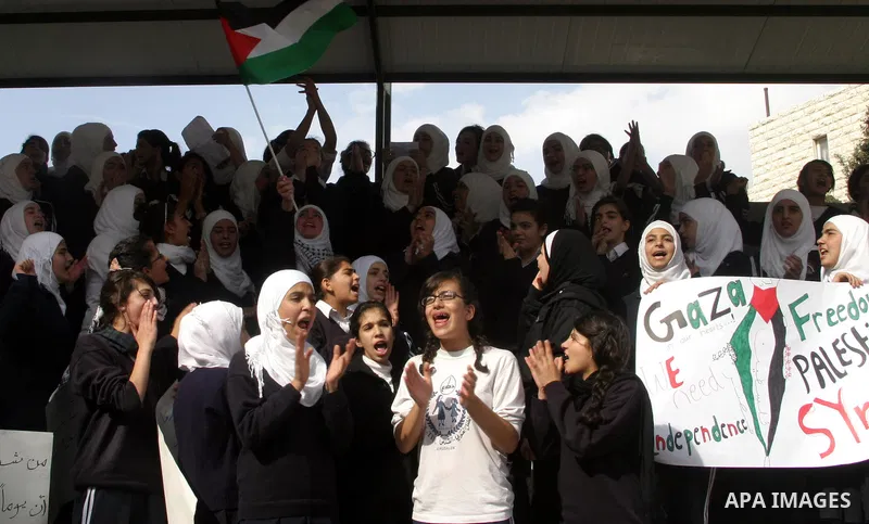 Palestinian students shout slogans during a protest against Israel's military operation in the Gaza Strip, in Jerusalem, on November 17, 2012. Reports state that Israel has put 75,000 reservists on standby amid speculati...