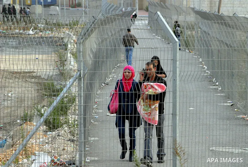 Palestinians pass through the Shuafat military checkpoint in the east Jerusalem on November 17, 2012. Palestinian militants nearly hit Jerusalem with a rocket for the first time in decades on Friday and fired at Tel Aviv...