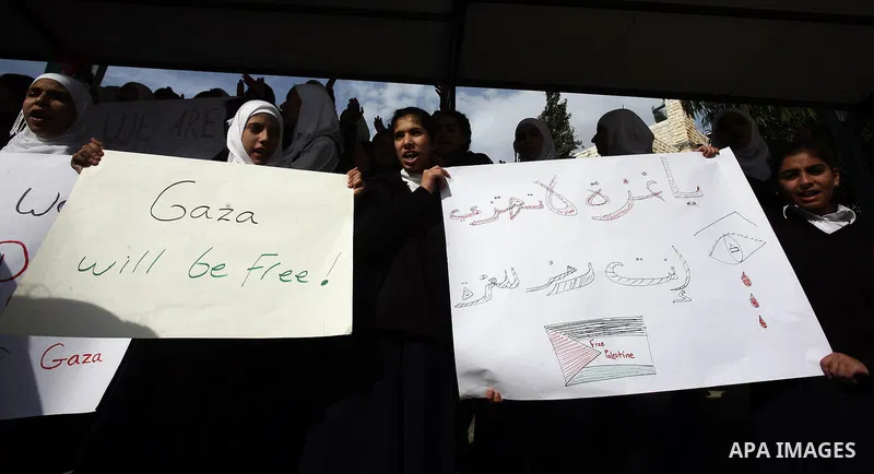 Palestinian students shout slogans during a protest against Israel's military operation in the Gaza Strip, in Jerusalem, on November 17, 2012. Reports state that Israel has put 75,000 reservists on standby amid speculati...