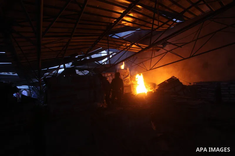 Palestinians try to extinguish a fire following an Israeli strike in Zeitun, outskirts of Gaza City, Saturday, Nov. 17, 2012. Israeli aircraft bombed Hamas government buildings in Gaza on Saturday, including the prime mi...