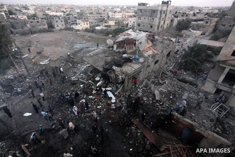 Palestinians inspect the damage in a Palestinian house after an Israeli strike in Zeitun, outskirts of Gaza City, Saturday, Nov. 17, 2012. Israeli aircraft bombed Hamas government buildings in Gaza on Saturday, including...