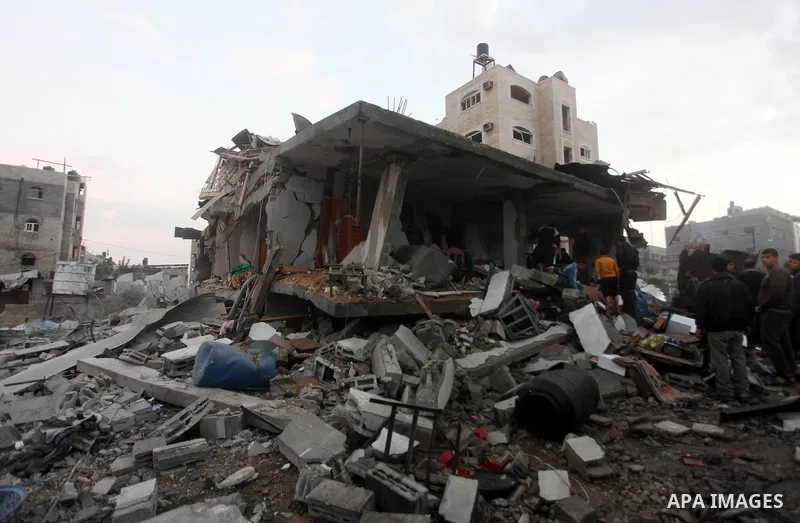 Palestinians inspect the damage in a Palestinian house after an Israeli strike in Zeitun, outskirts of Gaza City, Saturday, Nov. 17, 2012. Israeli aircraft bombed Hamas government buildings in Gaza on Saturday, including...