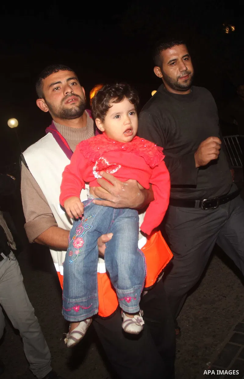 A Palestinian paramedic carries a wounded girl to Al-Shifa hospital in Gaza City on November 17, 2012. Israel bombarded the Hamas-ruled Gaza Strip with nearly 200 airstrikes early Saturday, the military said, widening a...