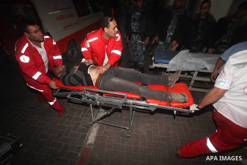 Palestinian paramedics wheel a wounded man to Al-Shifa hospital in Gaza City on November 17, 2012. Israel bombarded the Hamas-ruled Gaza Strip with nearly 200 airstrikes early Saturday, the military said, widening a blis...