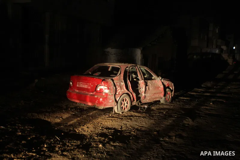 A photograph shows a destroyed car targeted by Israel airstrike in Zeitun, outskirts of Gaza City, Saturday, Nov. 17, 2012. Israel bombarded the Hamas-ruled Gaza Strip with nearly 200 airstrikes early Saturday, the milit...
