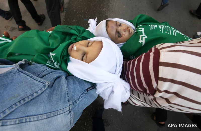 Palestinians carry the bodies of two children during their funeral in the northern Gaza Strip November 18, 2012. Two children Jumana Abu Seifan, 18 months old, and her brother Tamer, three and a half years old, were kill...