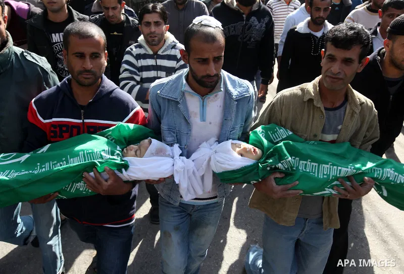 Palestinians carry the bodies of two children during their funeral in the northern Gaza Strip November 18, 2012. Two children Jumana Abu Seifan, 18 months old, and her brother Tamer, three and a half years old, were kill...