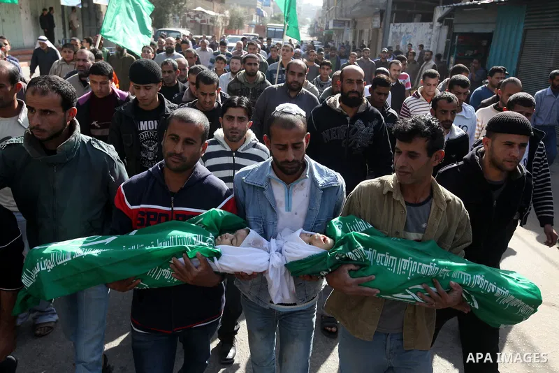 Palestinians carry the bodies of two children during their funeral in the northern Gaza Strip November 18, 2012. Two children Jumana Abu Seifan, 18 months old, and her brother Tamer, three and a half years old, were kill...