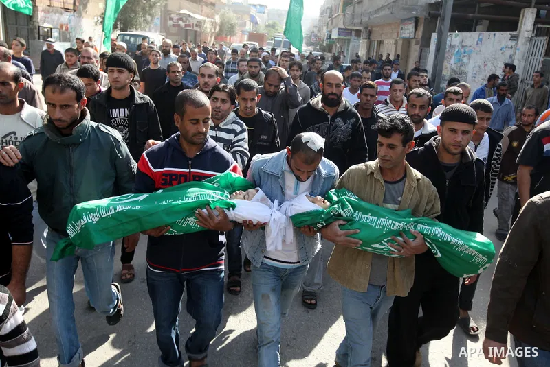 Palestinians carry the bodies of two children during their funeral in the northern Gaza Strip November 18, 2012. Two children Jumana Abu Seifan, 18 months old, and her brother Tamer, three and a half years old, were kill...